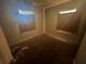 Modest bedroom with carpeted floor and minimal natural light at 80 Harlan Sw Rd, Atlanta, GA 30311