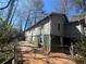 Side view of two-story home featuring green siding, white trim and fenced yard at 80 Harlan Sw Rd, Atlanta, GA 30311