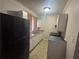Traditional kitchen with light countertops, white cabinets, and appliances at 80 Harlan Sw Rd, Atlanta, GA 30311