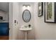 Charming half bathroom featuring a pedestal sink, updated lighting and modern accents at 1059 Park Row North Se, Atlanta, GA 30312