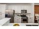 Bright kitchen features white cabinets, stainless steel appliances, marble counters, and herringbone backsplash at 1059 Park Row North Se, Atlanta, GA 30312