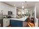 Modern kitchen featuring white cabinets, stainless steel appliances, an open layout, and wood floors at 1059 Park Row North Se, Atlanta, GA 30312