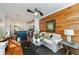 Bright living room featuring hardwood floors, a modern ceiling fan, and stylish accent wall at 1059 Park Row North Se, Atlanta, GA 30312