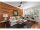 Inviting living room with hardwood floors, wood accent wall, and large windows, offering plenty of natural light at 1059 Park Row North Se, Atlanta, GA 30312