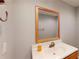 Bathroom featuring a sink with wood trim, a mirror, and white walls at 1294 Summit Chase Dr, Snellville, GA 30078