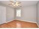 Bright bedroom with a ceiling fan, laminate floors, and a large window at 1294 Summit Chase Dr, Snellville, GA 30078