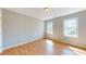 Bright bedroom featuring wood floors, neutral walls, and natural light from two windows at 1294 Summit Chase Dr, Snellville, GA 30078