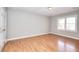 Neutral bedroom with laminated floors and a large window for natural light at 1294 Summit Chase Dr, Snellville, GA 30078