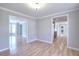 Elegant dining room with hardwood floors, adjacent to a kitchen view and a light fixture at 1294 Summit Chase Dr, Snellville, GA 30078