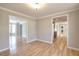 Bright dining room features hardwood floors and doorway views of the kitchen with dark cabinetry at 1294 Summit Chase Dr, Snellville, GA 30078