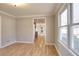 Open dining room with hardwood floors with views into the bright kitchen featuring dark cabinetry at 1294 Summit Chase Dr, Snellville, GA 30078