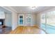 Dining area with wood floors, sliding doors to backyard, and view of a laundry room at 1294 Summit Chase Dr, Snellville, GA 30078