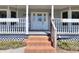 Inviting front porch with classic white railings and brick steps lead to the decorative front door at 1294 Summit Chase Dr, Snellville, GA 30078