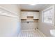 Laundry area with white cabinets, folding counter, and a window for natural light at 1294 Summit Chase Dr, Snellville, GA 30078