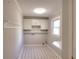 Bright laundry room with white cabinets, a folding counter, and patterned flooring at 1294 Summit Chase Dr, Snellville, GA 30078