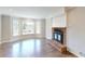 Bright living room featuring a red brick fireplace and large bay window with neighborhood views at 1294 Summit Chase Dr, Snellville, GA 30078