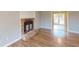 Living room with a brick fireplace, neutral walls and base trim, and wood laminate flooring at 1294 Summit Chase Dr, Snellville, GA 30078