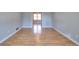 Open room featuring light hardwood floors and light grey walls at 1294 Summit Chase Dr, Snellville, GA 30078