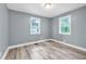 Comfortable bedroom features soft blue walls, hardwood floors, and bright natural light at 225 Joe Louis Nw Dr, Atlanta, GA 30314