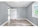 Bright bedroom with soft blue walls, hardwood floors, white trim, and bright natural light at 225 Joe Louis Nw Dr, Atlanta, GA 30314