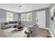 Cozy living room with hardwood floors, soft blue walls, neutral furniture, and bright natural light at 225 Joe Louis Nw Dr, Atlanta, GA 30314