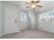 Bedroom with natural light, two windows, neutral walls, and a ceiling fan at 4555 Cedar Heights Ct, Stone Mountain, GA 30083