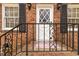 Close-up of a front door with iron railings and brick facade at 4555 Cedar Heights Ct, Stone Mountain, GA 30083