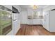 Well-lit kitchen featuring white cabinets, modern appliances, and stylish finishes at 4555 Cedar Heights Ct, Stone Mountain, GA 30083