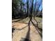 A cement backyard patio with mature trees creating ample shade at 4809 Thompson Mill Rd, Lithonia, GA 30058