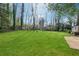 Expansive backyard featuring lush green grass and surrounding mature trees offering privacy at 4809 Thompson Mill Rd, Lithonia, GA 30058