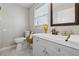 Bathroom features a grey vanity, toilet, and modern finishes at 4809 Thompson Mill Rd, Lithonia, GA 30058