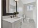 Bathroom with marble-top vanity, stylish black faucet, a decorative plant, and a tiled floor at 4809 Thompson Mill Rd, Lithonia, GA 30058