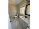 Bathroom featuring a modern vanity, stylish mirror, and natural light from the window at 4809 Thompson Mill Rd, Lithonia, GA 30058