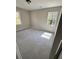 Light-filled bedroom with neutral walls, carpet, and two bright windows at 4809 Thompson Mill Rd, Lithonia, GA 30058