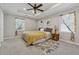 Cozy bedroom with trey ceiling, carpet, and natural light from two windows at 4809 Thompson Mill Rd, Lithonia, GA 30058