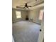 Spacious carpeted bedroom with ceiling fan, recessed ceiling, and plenty of natural light at 4809 Thompson Mill Rd, Lithonia, GA 30058