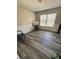 Bright bedroom showcasing new flooring, chair rail trim, and natural light streaming through the windows at 4809 Thompson Mill Rd, Lithonia, GA 30058