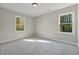 Neutral bedroom with two windows overlooking outdoor foliage at 4809 Thompson Mill Rd, Lithonia, GA 30058