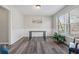 Dining room with wainscoting, wood-look floors, a modern light fixture, and a large window at 4809 Thompson Mill Rd, Lithonia, GA 30058