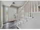 Bright foyer with white trim staircase, luxury vinyl flooring and sidelight windows at 4809 Thompson Mill Rd, Lithonia, GA 30058