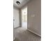 Carpeted hallway with two doorways, one leading to a room with natural light at 4809 Thompson Mill Rd, Lithonia, GA 30058