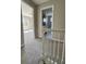 Hallway view with neutral carpet leading into a bright, window-lit bedroom at 4809 Thompson Mill Rd, Lithonia, GA 30058