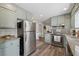 Bright kitchen with granite countertops, stainless steel appliances, and sage green cabinetry at 4809 Thompson Mill Rd, Lithonia, GA 30058