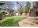 Landscaped backyard featuring a stone patio with a fire pit and ample seating, complemented by a grassy lawn at 625 Glenwood Se Pl, Atlanta, GA 30316