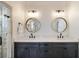 Bathroom featuring double vanity, quartz countertops, and tile shower with glass door at 625 Glenwood Se Pl, Atlanta, GA 30316