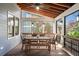 This is a stunning covered patio area with a dining table set for six and beautiful wood floors at 625 Glenwood Se Pl, Atlanta, GA 30316