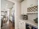 Bright kitchen boasts custom cabinetry, wine rack, stainless appliances, and coffee bar with espresso machine at 625 Glenwood Se Pl, Atlanta, GA 30316