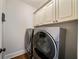 Laundry room featuring front loading washer and dryer, custom cabinets at 625 Glenwood Se Pl, Atlanta, GA 30316