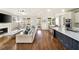 Open-concept living room featuring hardwood floors, fireplace, and seamless flow into the kitchen and porch at 625 Glenwood Se Pl, Atlanta, GA 30316