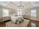 Inviting main bedroom featuring tray ceiling, chandelier, and sitting area at 625 Glenwood Se Pl, Atlanta, GA 30316